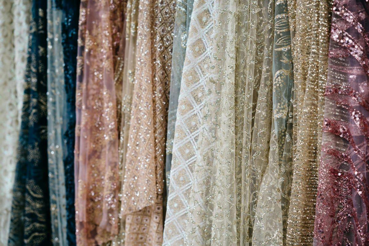 Bridal fabric swatches laid out for selection at Lavender Fashions, Doha